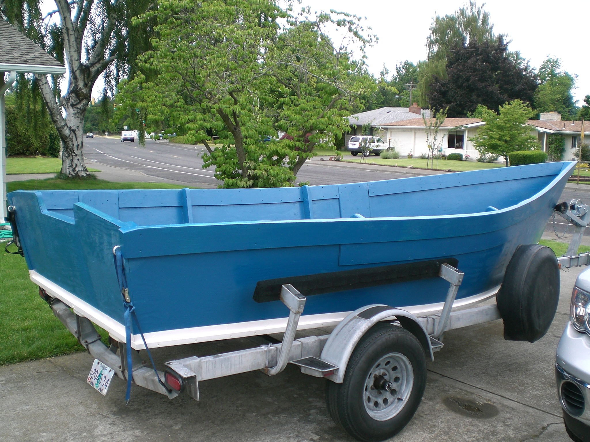 A blue customer-built Lady Bug skiff on its trailer