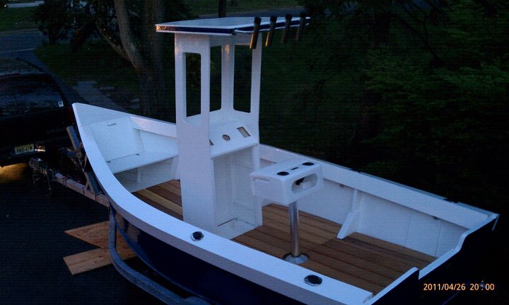A white customer-built Lady Bug skiff on a trailer